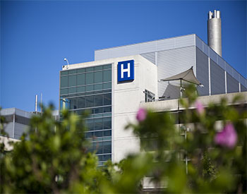 Modern hospital and sign with clear blue sky